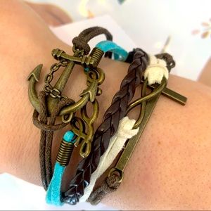 Multi strand bracelet with anchor, love, cross and infinity symbols